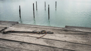 Malaysia, Denawan island, 2024-05-09. Speargun and traditional diving goggles on a deck in a Bajau village. Photograph b