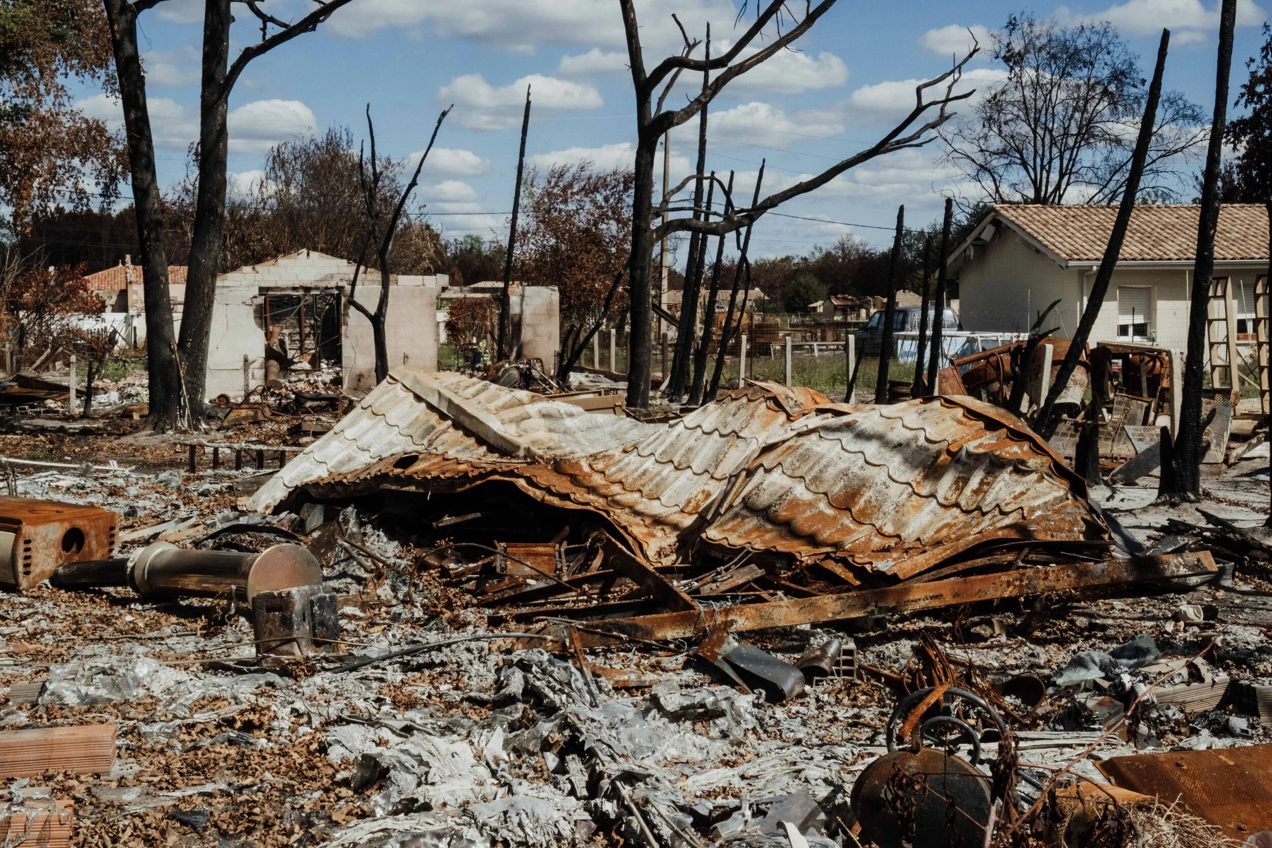 France, Nouvelle Aquitaine, Gironde, Le Porge, July 2026. A destroyed residential property stands amid burned vegetation