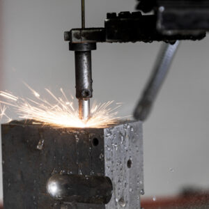 France, Bouttencourt, 2023-02-23. Shower of sparks as a steel block is drilled in a machining workshop. Photograph by An