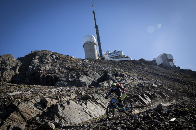 France, Bagneres-de-Bigorre, 2019-09-28. Alexis Righetti rides the highest ridges of the Pyrenees, carrying his bike whe