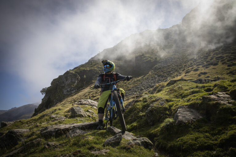 France, Bagneres-de-Bigorre, 2019-09-28. Alexis Righetti rides the highest ridges of the Pyrenees, carrying his bike whe