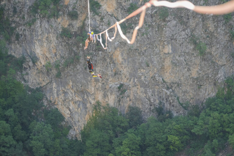 Croatia, Imotski, 2018-05-04. Above the Red Lake, a collapsed karst sinkhole near Imotski, a team rigs highlines and jum