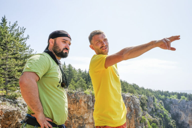 Croatia, Imotski, 2018-05-02. Above the Red Lake, a collapsed karst sinkhole near Imotski, a team rigs highlines and jum