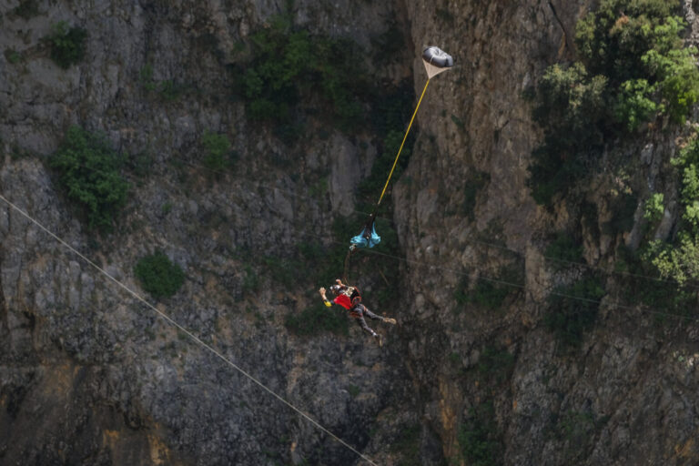 Croatia, Imotski, 2018-05-04. Above the Red Lake, a collapsed karst sinkhole near Imotski, a team rigs highlines and jum