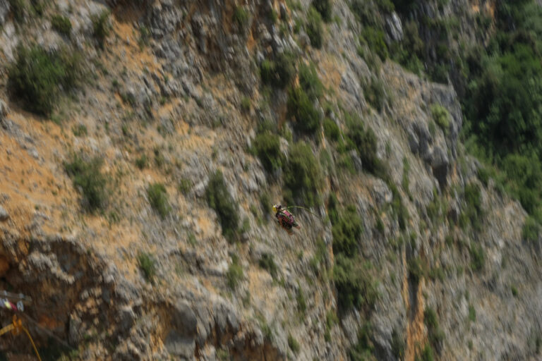 Croatia, Imotski, 2018-05-11. Above the Red Lake, a collapsed karst sinkhole near Imotski, a team rigs highlines and jum