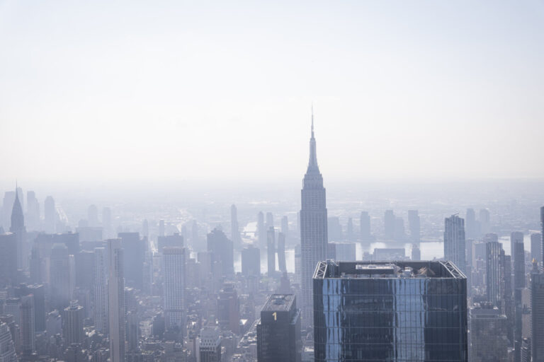 United States, New York, 2026-08-07. The Empire State Building rising out of the summer haze over Midtown. Photograph by