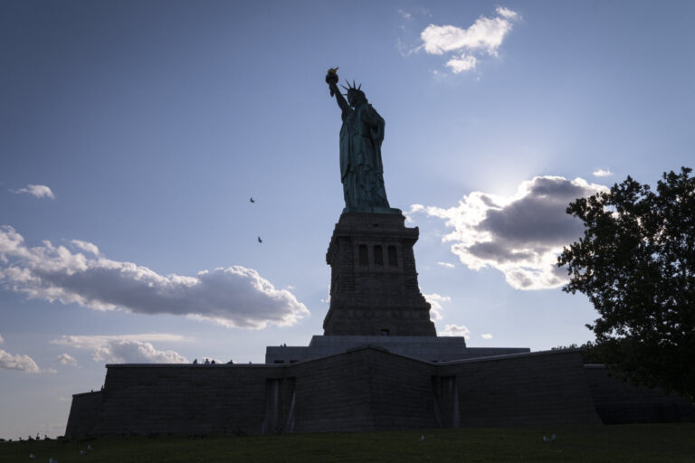 United States, New York, 2026-08-15. The silhouette of the Statue of Liberty above the walls of Fort Wood. Photograph by