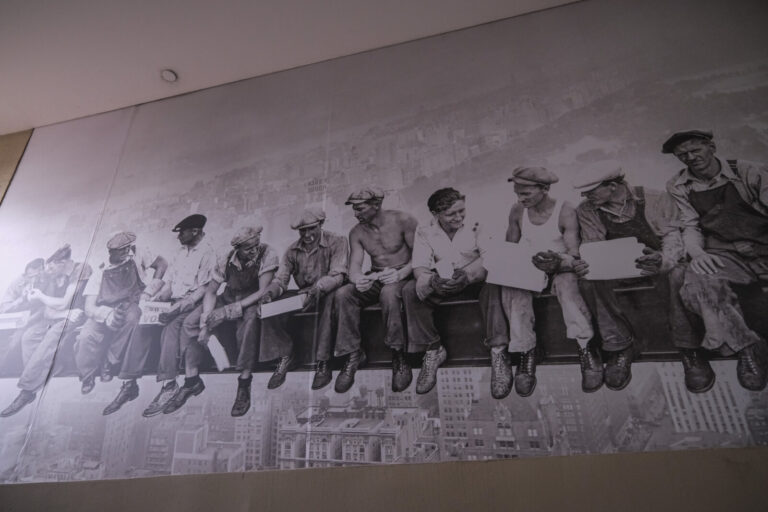 United States, New York, 2026-08-17. A reproduction of the photograph of workers having lunch on a beam, displayed at th