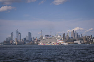 United States, Jersey City, 2026-08-15. A cruise ship moored in front of the skyline of Midtown Manhattan. Photograph by