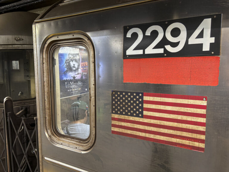 United States, New York, 2026-08-08. Subway car number 2294 with an advertisement for Les Miserables visible through the