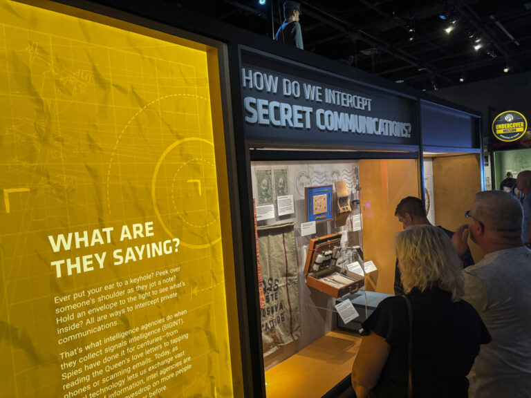 United States, Washington, 2026-08-12. A section on the interception of secret communications, with visitors at a displa