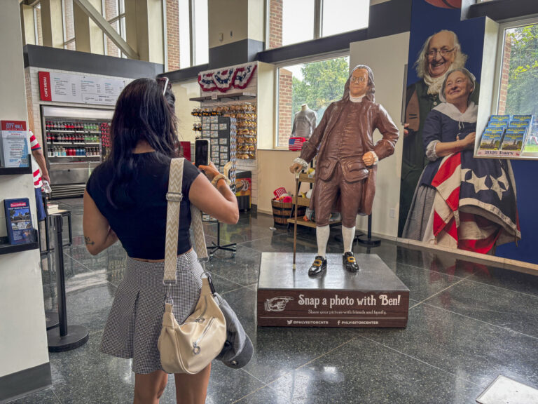 United States, Philadelphia, 2026-08-14. A visitor photographs the statue of Benjamin Franklin at the Independence Visit