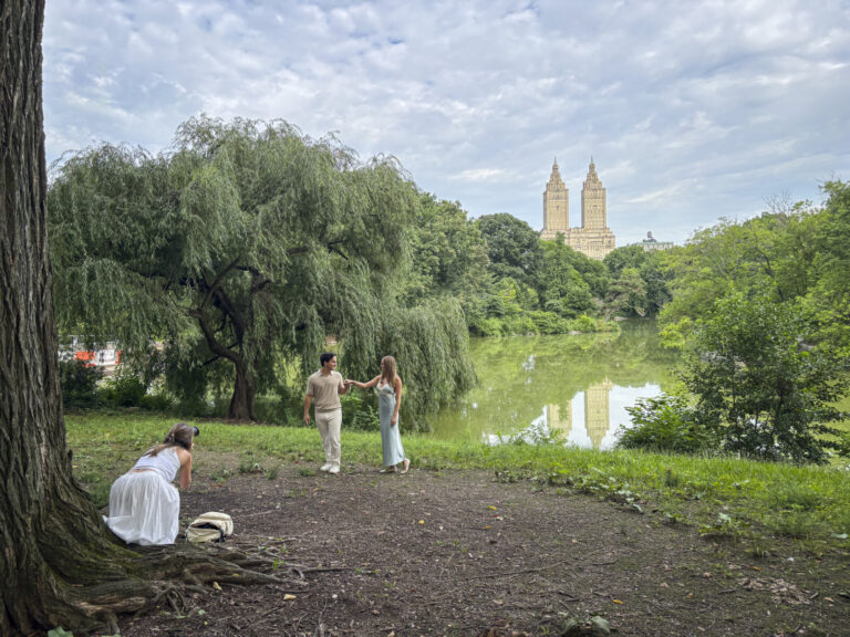 United States, New York, 2026-08-05. A couple poses for a photographer on the bank of the Lake in Central Park. Photogra
