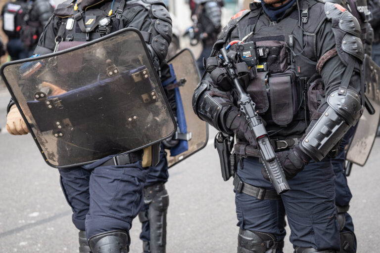 France, Lyon, 2023-03-07. Close up on the equipment and weapons of the police officers guarding the demonstration agains