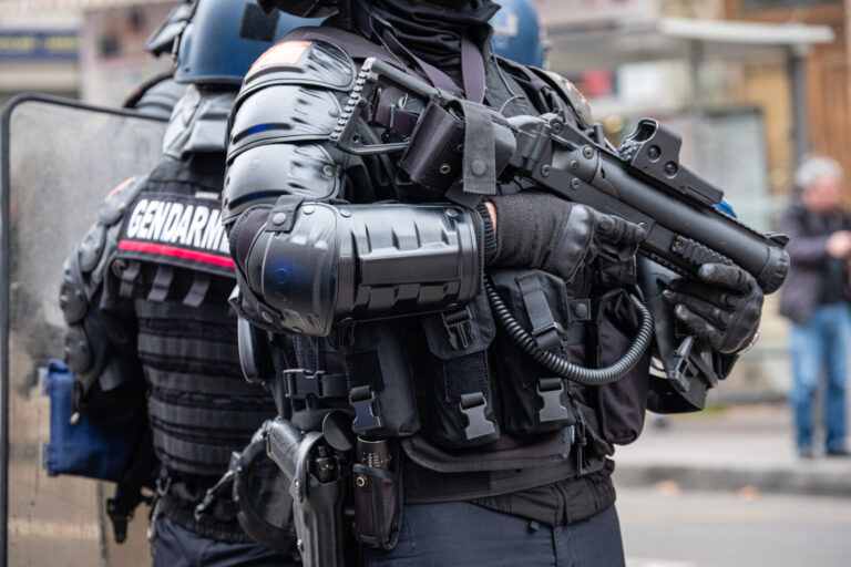 France, Lyon, 2023-03-07. Close up on the equipment and weapons of the police officers guarding the demonstration agains