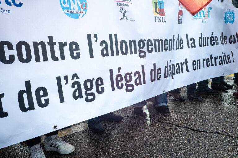 France, Lyon, 2023-01-19. Demonstration against the government's pension reform. The head banner in close-up with the fe