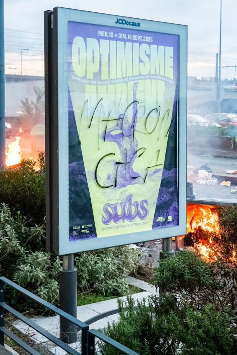 France, Lyon, 2025-09-10. An advertising billboard with an optimistic poster and Macron's face defaced with excrement, w