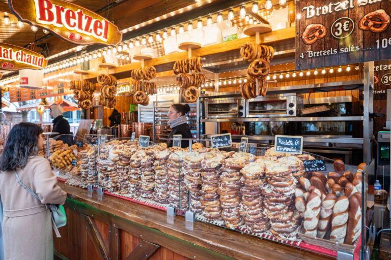 France, Lyon, 2025-11-25. A pretzel stand at the Christmas market on Place Carnot, which has just opened its doors a mon