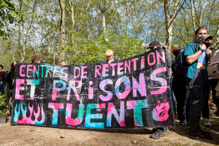 France, Lyon, 2023-09-23. A united march for social justice, against police violence and racism. Coloured banner: detent
