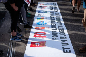 France, Lyon, 2026-09-29. Protest and national civil service strike, with the lead banner on the ground before the demon