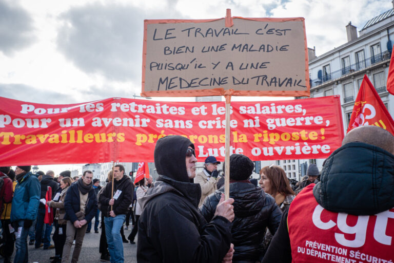 France, Lyon, 2023-01-31. Demonstration against the government's pension reform. A demonstrator with a sign in front of 