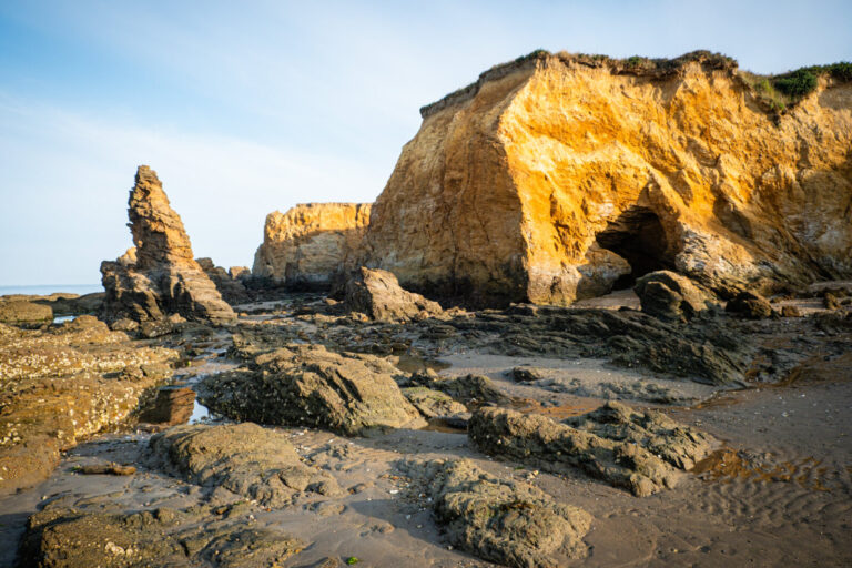 France, Penestin, 2025-08-03. Cliffs and boulders on the coastline at low tide showing signs of erosion. Photography by 