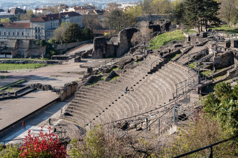 France, Lyon, 2023-04-05. View of the Gallo-Roman remains of the ancient theatre with a visitor climbing the steps of th