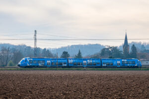 France, Civrieux d Azergues, 2024-01-30. A blue TER from the Auvergne Rhone Alpes region passing a village and farmland.
