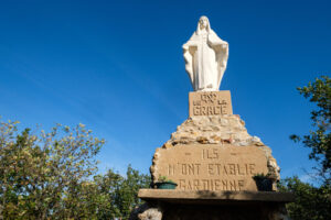 France, Saint des vignes, 2023-10-04. Madonna statue also called notre dame de la grace on a blue sky background. Photog