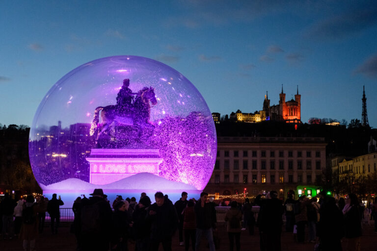 France, Lyon, 2024-12-04. The statue of King Louis XIV on the Place Bellecour in a snow globe for the Fete des Lumieres.