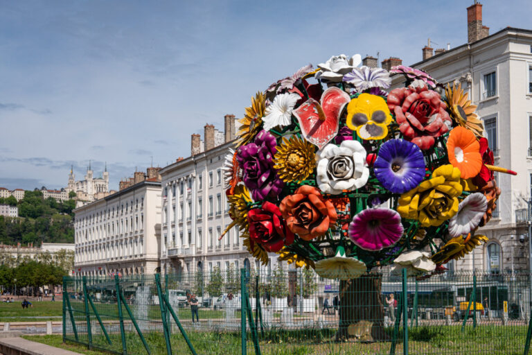 France, Lyon, 2023-04-27. The giant flower bouquet also called flower tree with the Fourviere basilica in the background