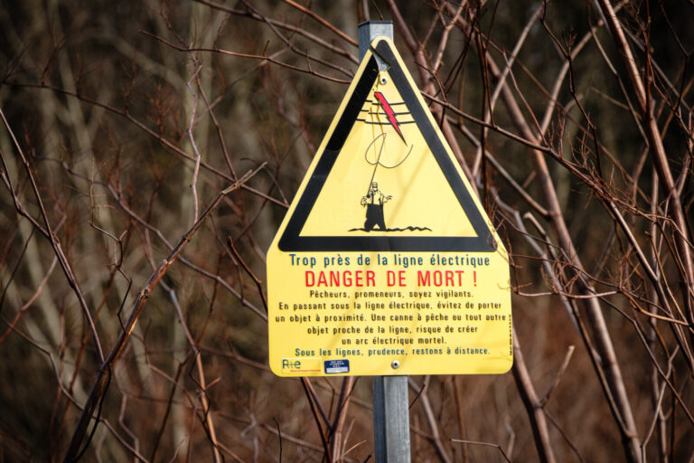 France, Civrieux d Azergues, 2024-01-30. A death danger sign in the shape of a yellow triangle warning fishermen and wal