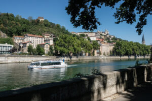 France, Lyon, 2022-07-14. View of the city of Lyon from the quays of the Saone. With the Navilys shuttle on the saone ri