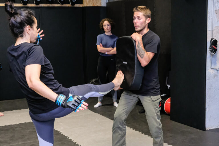 France, Lyon, 2021-10-14. Lyon (France), le 14 octobre 2021. Cours de krav maga avec une femme qui frappe du pied un bou