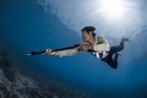Malaysia, Denawan, 2024-05-09. Bajau Laut man spearfishing in the reef with traditional gogles. Photograph by Gilles Aur