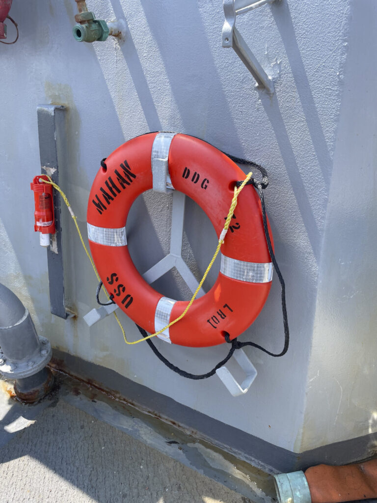 Canada, Quebec City, 2026-07-25. A life preserver ring marked 'USS Mahan DDG' is mounted on the hull of the American gui