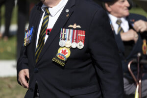 Canada, Drummondville, 2026-09-12. A Canadian Legion veteran displays military medals and a Royal Canadian Legion badge