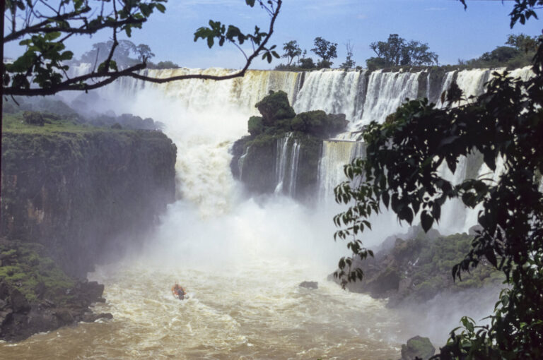 Argentine, Iguazu, 2005-01-20. Boats filled with tourists approach the waterfalls as closely as possible for a spectacul