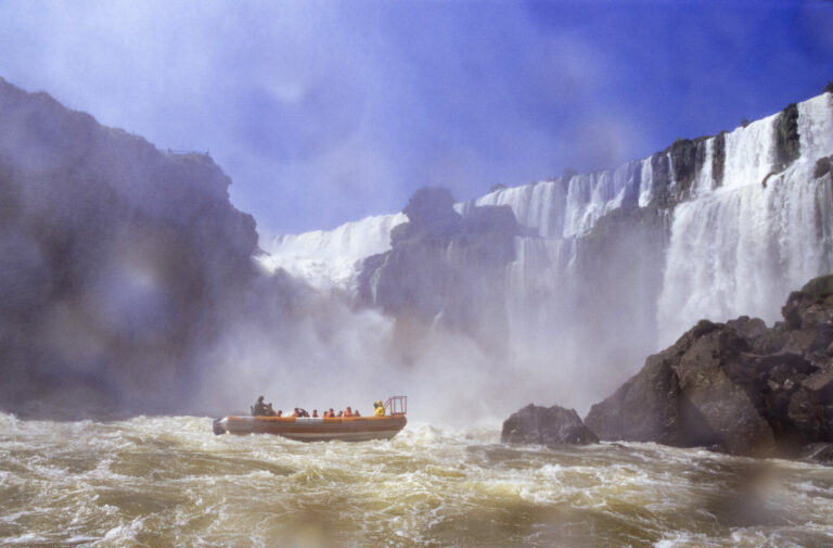 Argentine, Iguazu, 2005-01-20. Boats filled with tourists approach the waterfalls as closely as possible for a spectacul