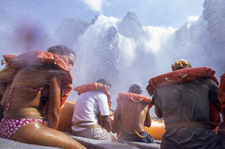 Argentine, Iguazu, 2005-01-20. Boats filled with tourists approach the waterfalls as closely as possible for a spectacul