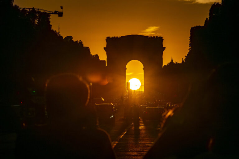 France, Paris, 2022-08-02. Each year, as August approaches, the sun sets in perfect alignment with the avenue of the Cha
