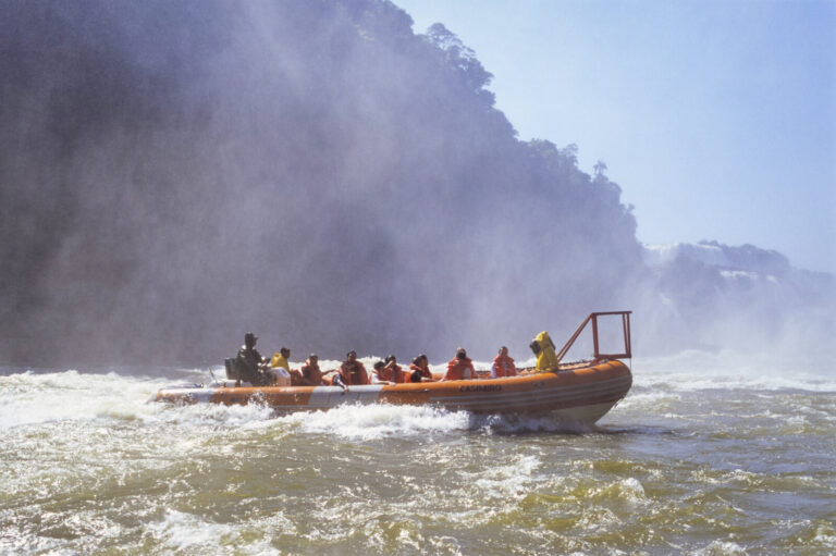 Argentine, Iguazu, 2005-01-20. Boats filled with tourists approach the waterfalls as closely as possible for a spectacul