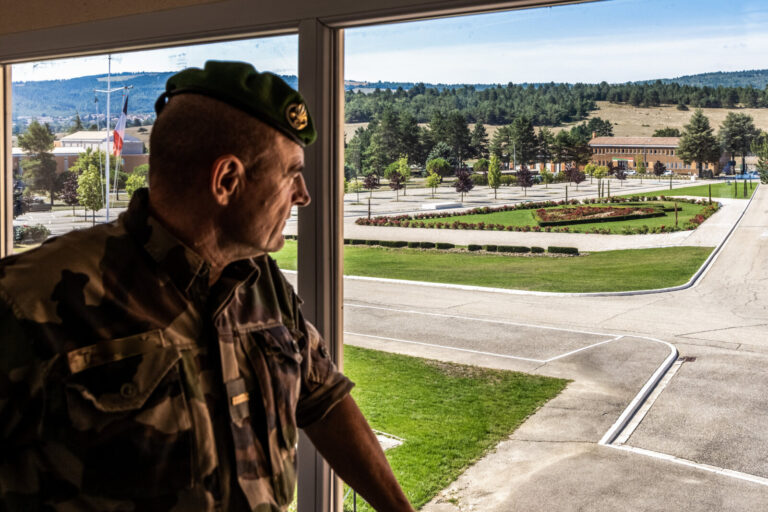 France, Saint-Christol, 2021-09-07. A legionnaire in uniform looks out of a window onto the parade ground. Photograph by
