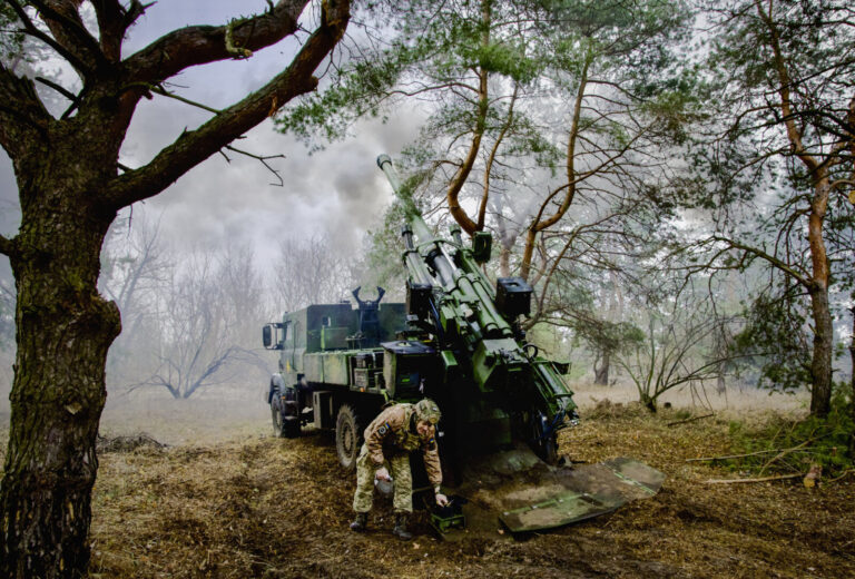 Ukraine, 2026-03-19. Ukraine, March 2026. Caesar cannon and a HUMVEE driving through a no-man's-land equipped with an an