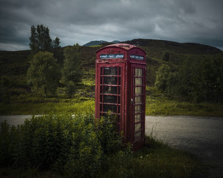 Scotland, Highlands, 2017-06. On the side of the road, a red public telephone box, typical of Great Britain. Scan from a