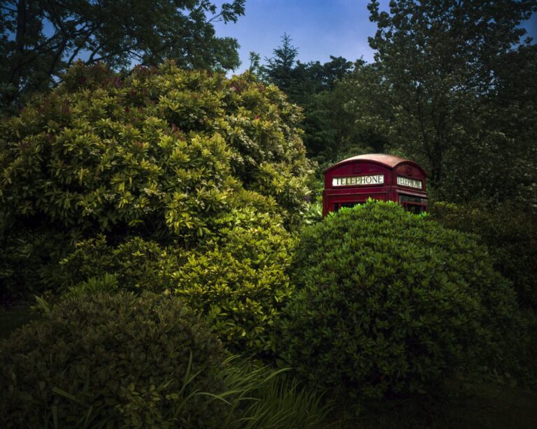 Scotland, Highlands, 2017-06. On the side of the road, a red public telephone box, typical of Great Britain. Scan from a