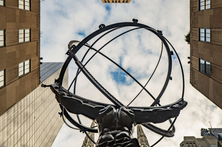 USA, New York, 2024-12-03. View from below of the famous Atlas statue in front of Rockefeller Center in New York City. T