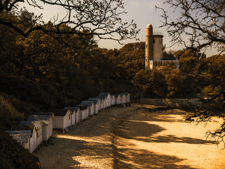 France, Noirmoutier en l ile, 2021-04-16. The beach cabins and the Plantier Tower on Anse Rouge beach on the island of N