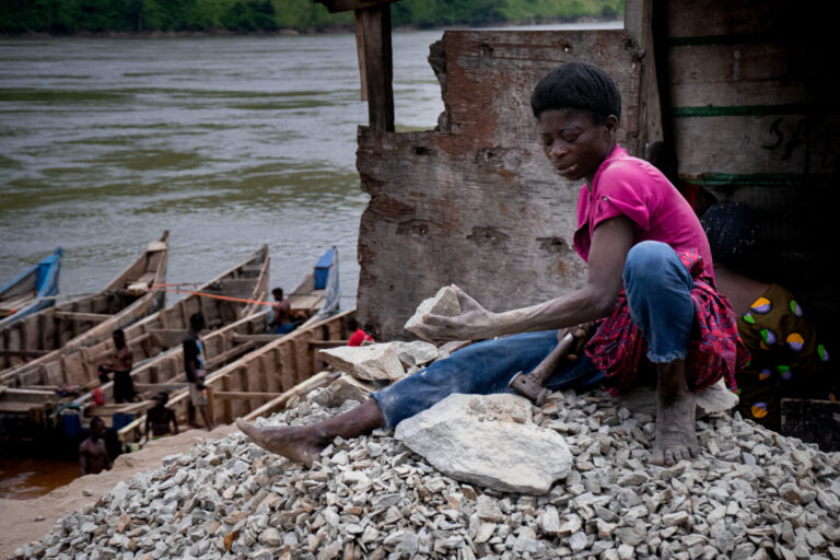 Democratic Republic of Congo, Matadi, 2024-10-20. Along the Congo River in Matadi, a woman breaks stones, contributing t