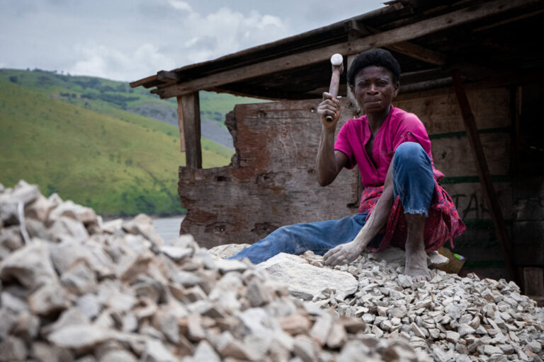Democratic Republic of Congo, Matadi, 2024-10-20. Along the Congo River in Matadi, a woman breaks stones, contributing t